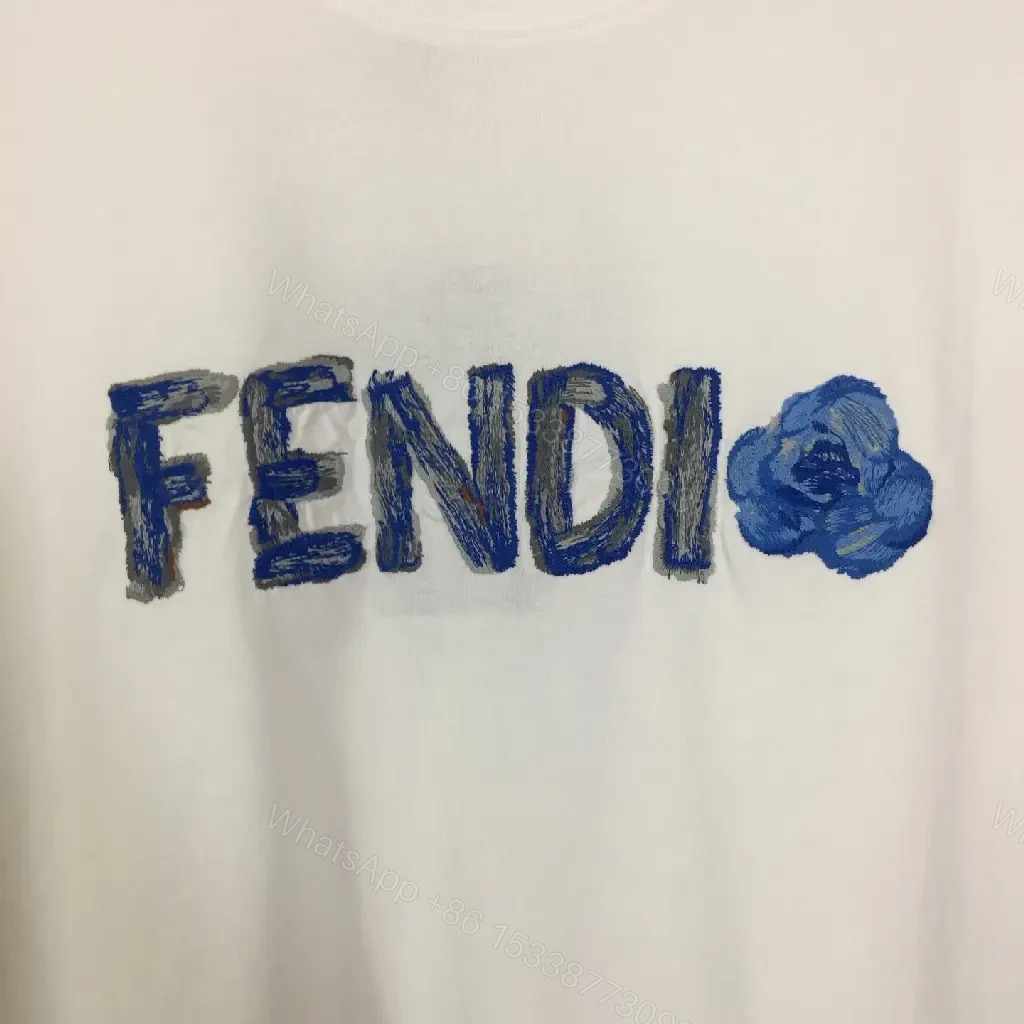 View 4 of White Cotton/Poly blend Short-sleeve Crew Neck Bold FENDI logo with blue flower T-shirt