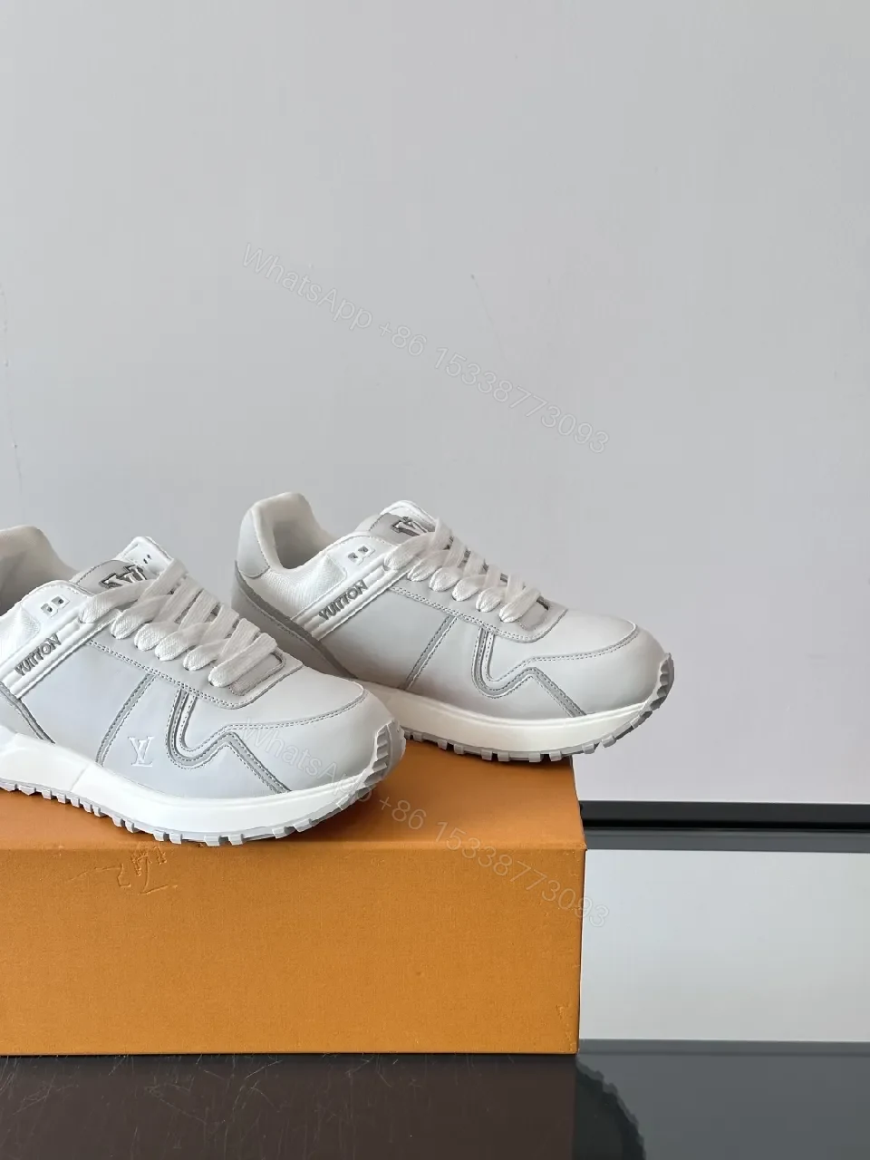 View 9 of Minimalistic White Leather Sneakers with Subtle Texture and Monogram Accent