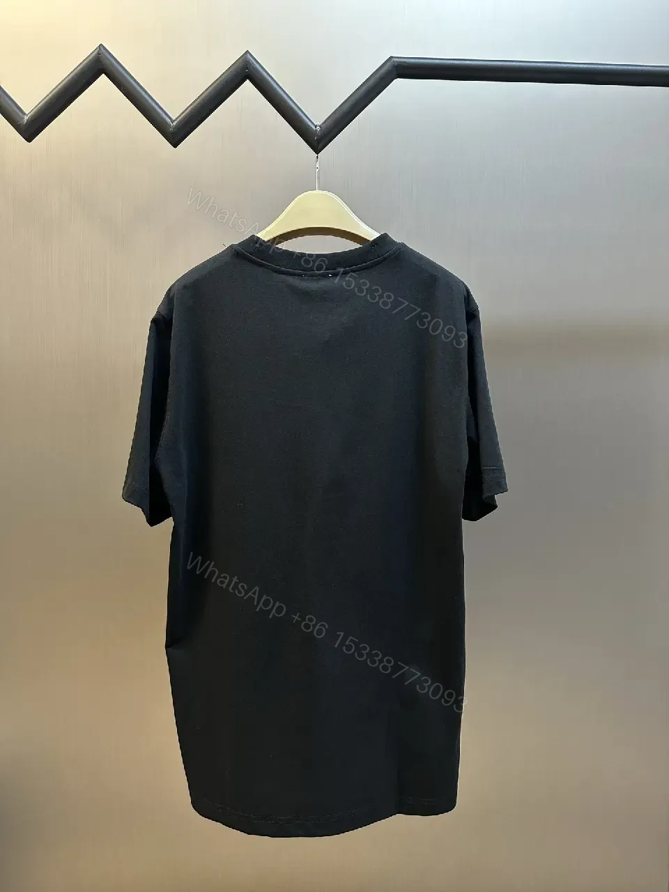 View 3 of Minimalist Black Cotton Tee | Relaxed Fit, Logo Accent, Everyday Luxury