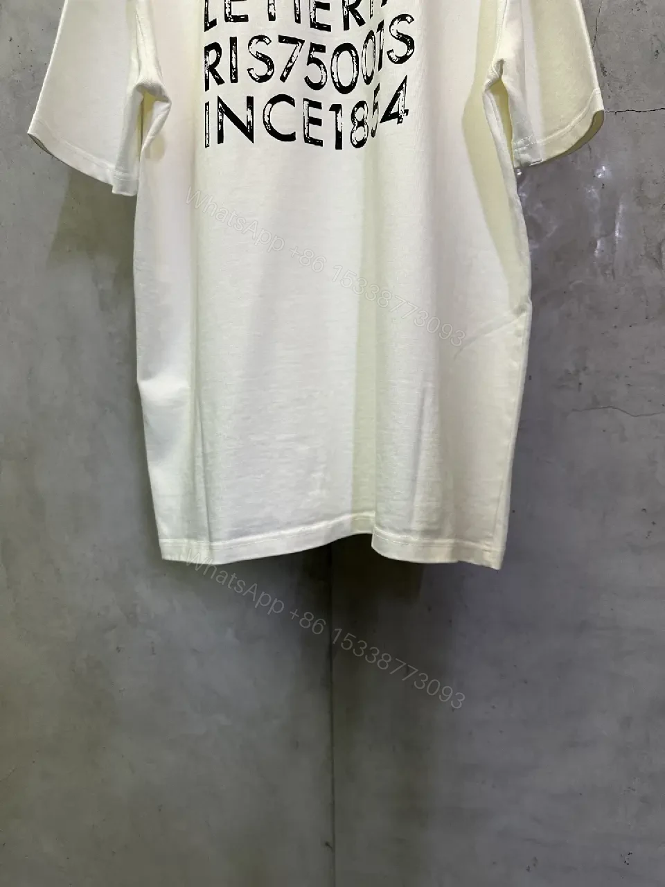 View 3 of Minimalist White Tee with Subtle LV.M. Marking — Premium Everyday Wear