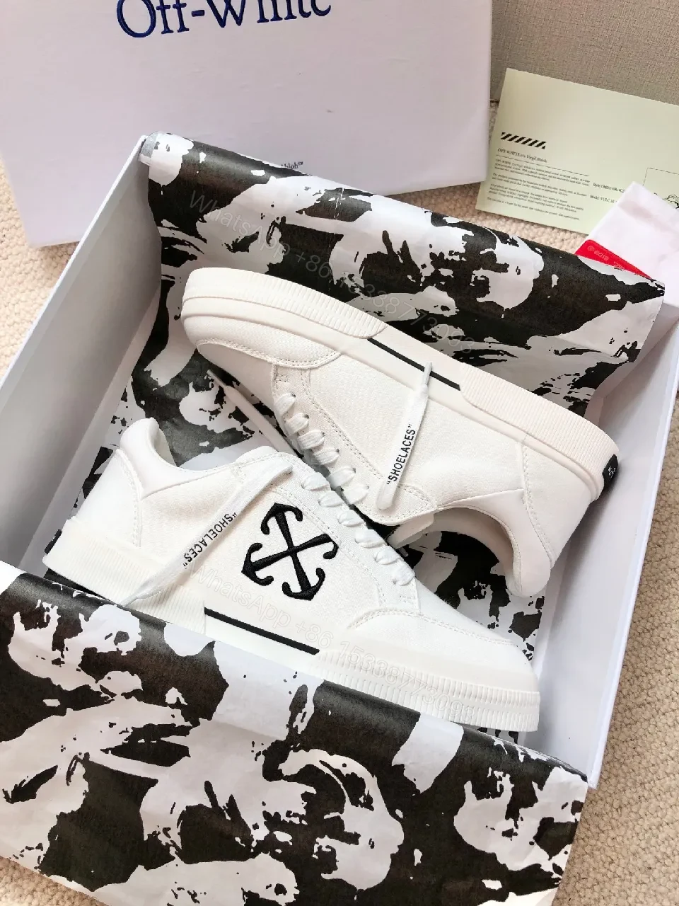 View 2 of Minimalist White Leather Low-Top Sneakers with Signature Detail