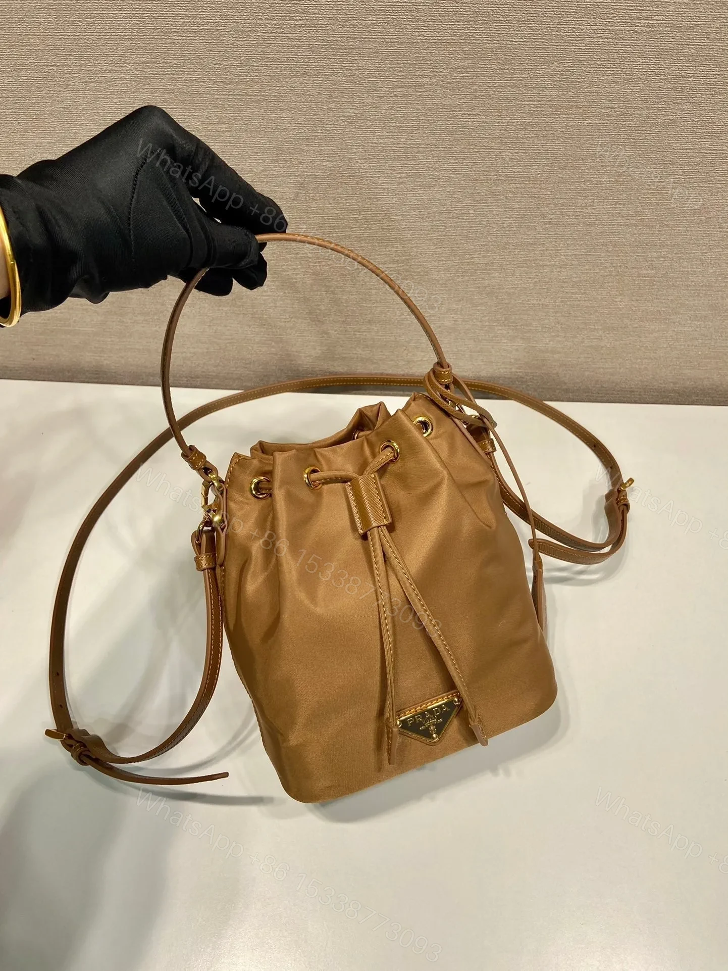 View 2 of BUCKET BAG 19 IN RUSSET BROWN RE-NYLON AND CALFSKIN HANDLE