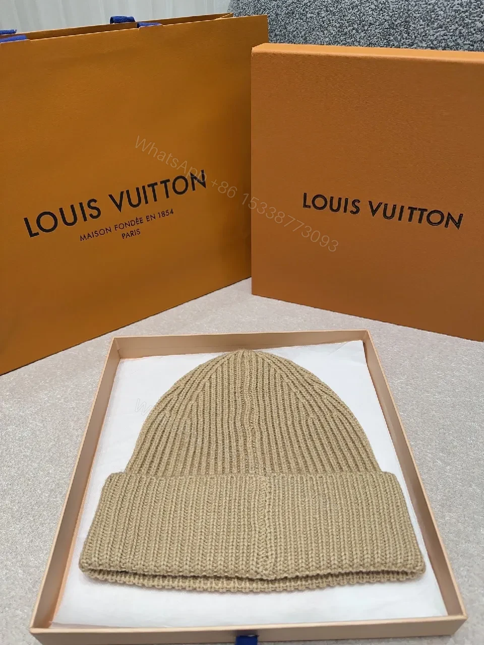 View 5 of Textured Camel Knit Beanie with Gold Crest - Cozy Luxury Style