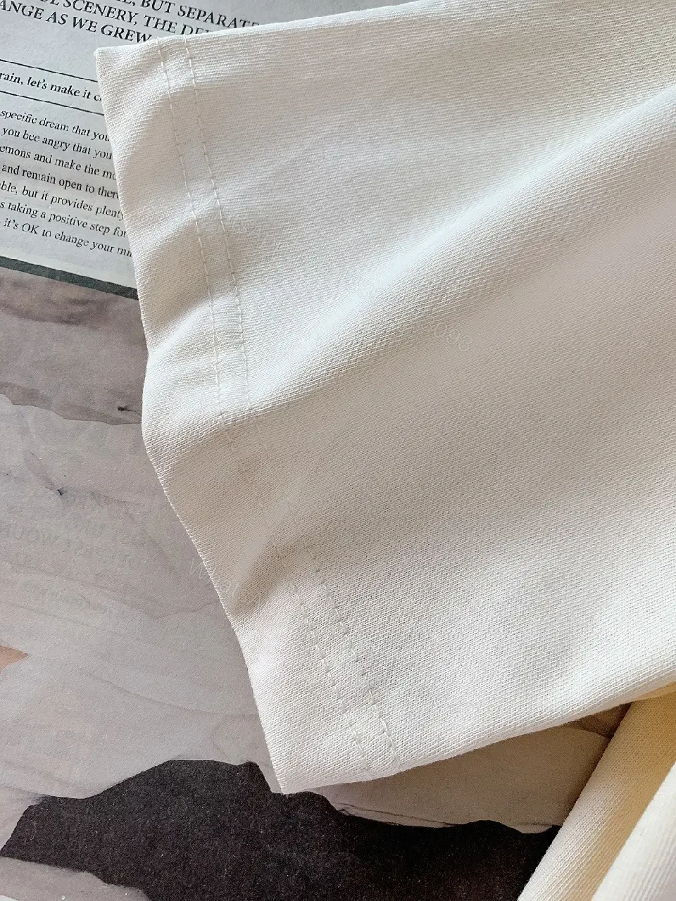 View 2 of Minimalist Off-White Cotton Tee with Signature L.V.M. Accent