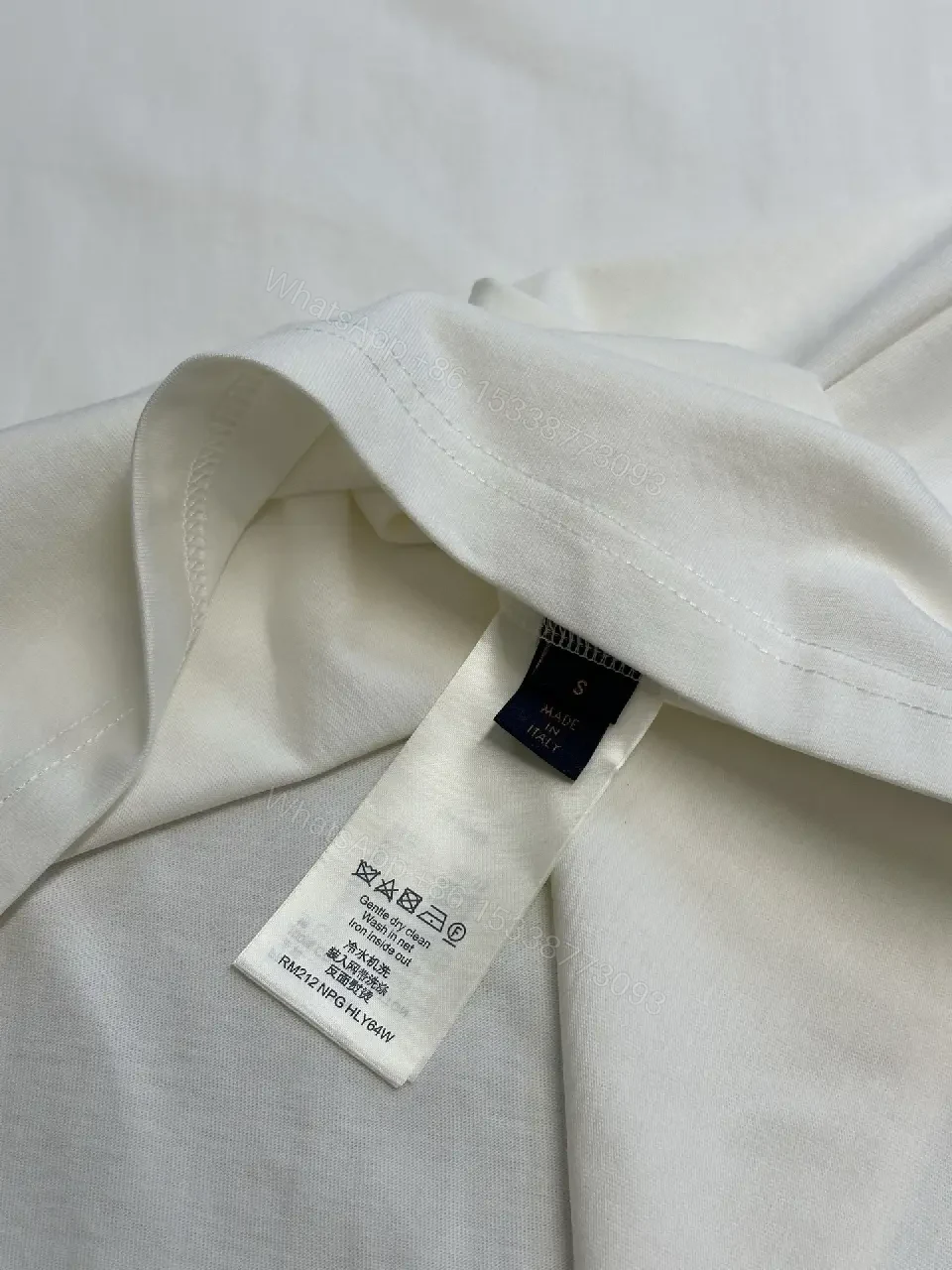 View 5 of Oversized White Tee with Subtle Embossed Logo - Minimal Luxury
