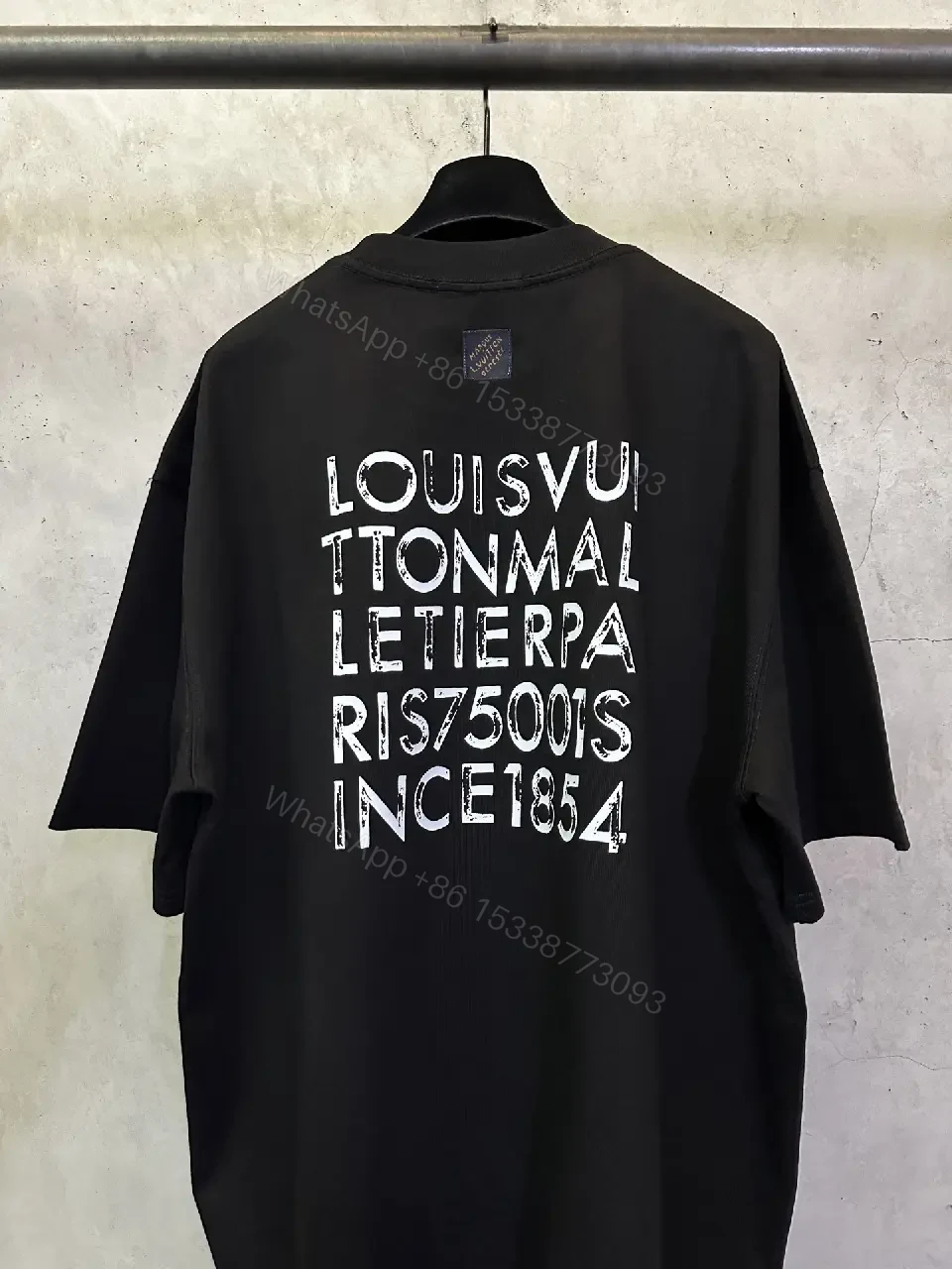 View 10 of Minimalist Black Tee with Subtle LV.M Emblem, Lux Cotton