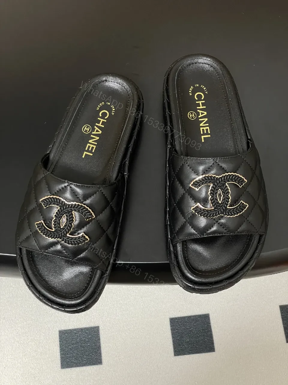 View 2 of Quilted Black Slip-Ons with Gold Emblem – Luxe Style