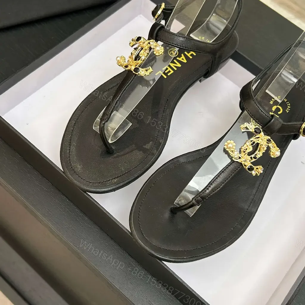 View 10 of Minimalist Black Leather Sandals with Gold Charms - Elegant Comfort