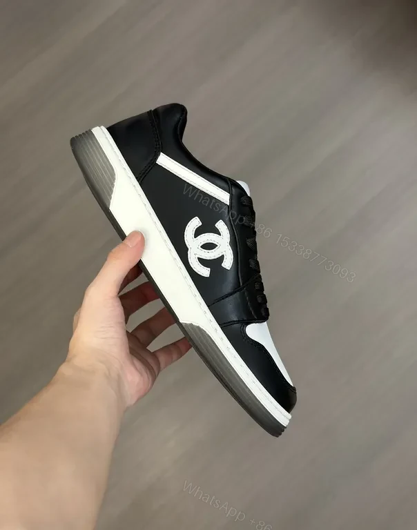 Monochrome Chanel-Style Low-Top Sneakers with Signature Emblem — view 1