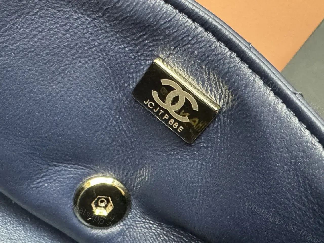 View 6 of Quilted Leather Mini Bag with Gold Emblem - Compact Glamour