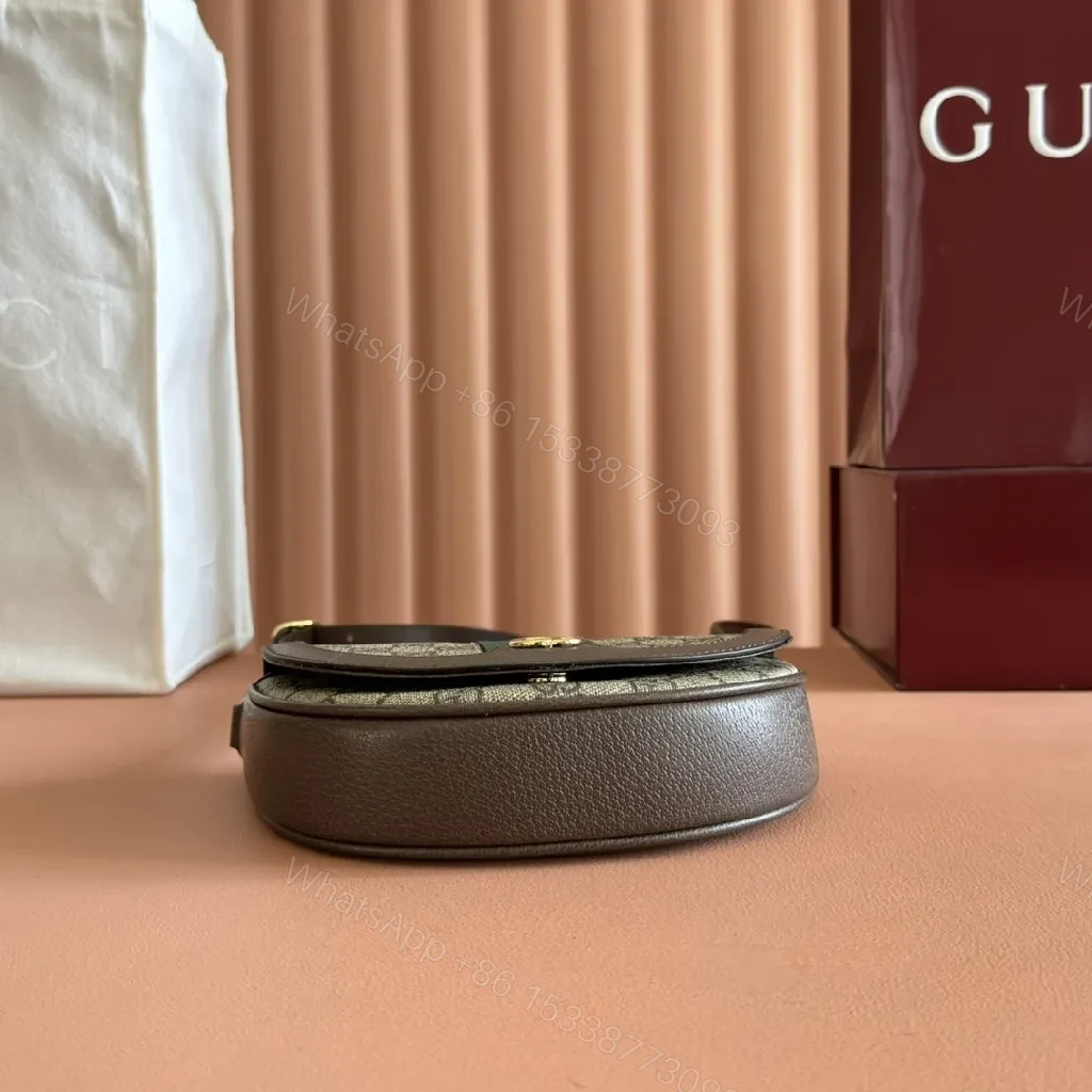 View 5 of Green Canvas Saddle Bag: Luxe Crossbody with Web Stripe and Gold Hardware