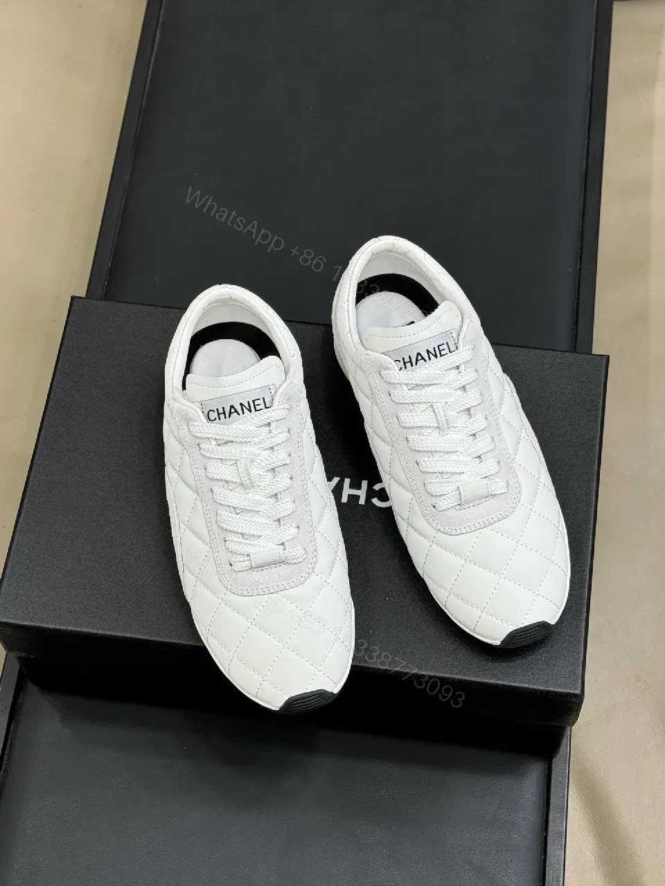 View 3 of White Quilted Leather Low-Top Sneakers with Signature Detailing