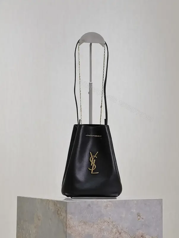 Black leather bucket bag with gold-tone YSL monogram and chain straps for everyday luxury — view 1