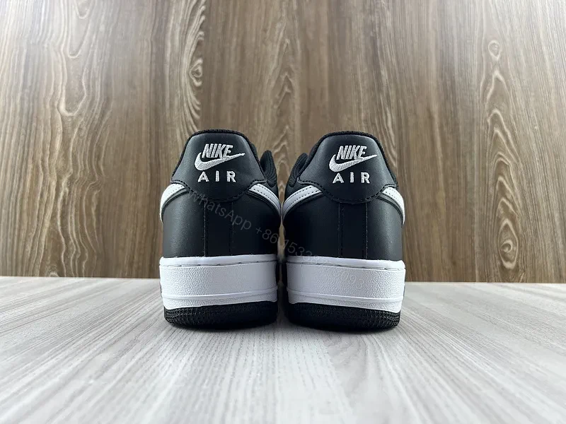 View 6 of Black Leather Low-Top Sneakers with Signature Swoosh
