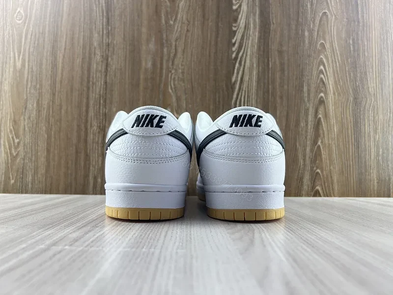 View 8 of Minimal White & Black Nike-Style Sneaker with Gum Sole