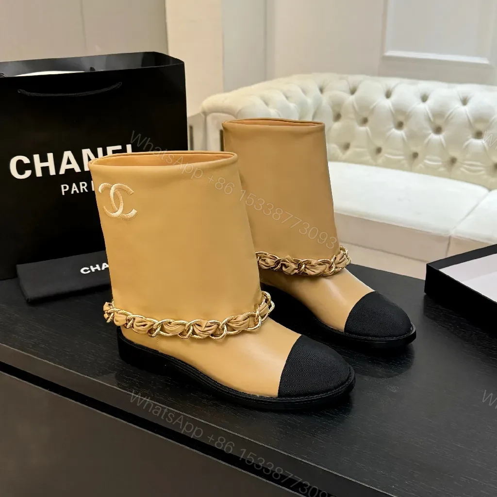 Chic Tan Leather Boots with Black Toe Cap and Chain Detail — view 1