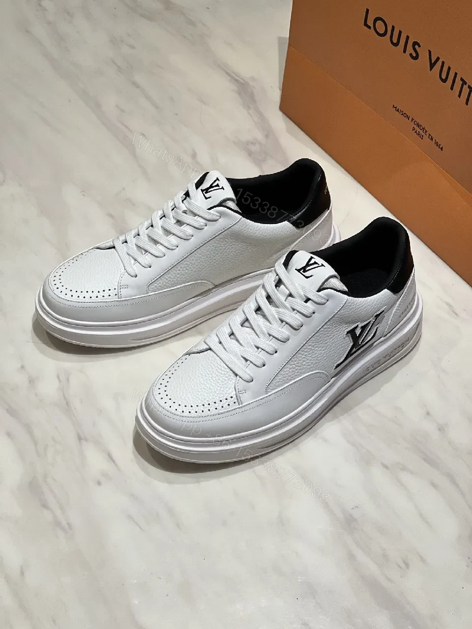 View 8 of Minimalist White Leather Sneakers with Signature Detail - Modern Luxury