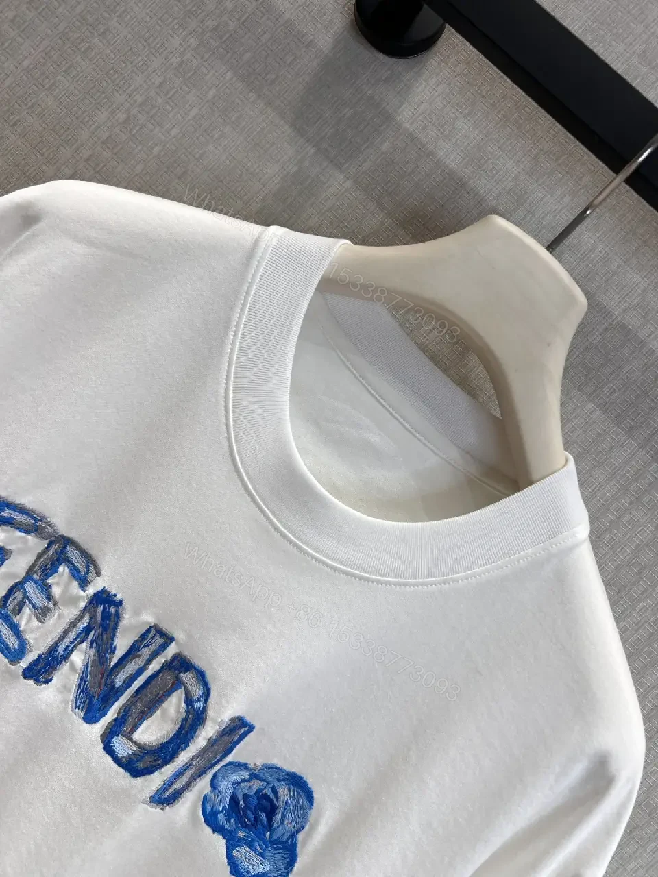 View 11 of Minimalist White Tee with Luxe Embroidered Logo, Casual-Ready Top