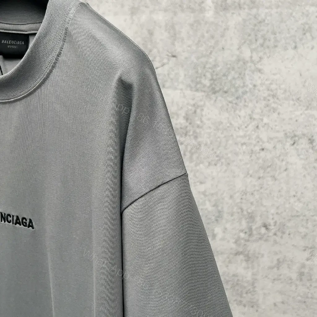 View 10 of Neutral Cotton Oversized Tee: Minimal Logo, Elevated Comfort