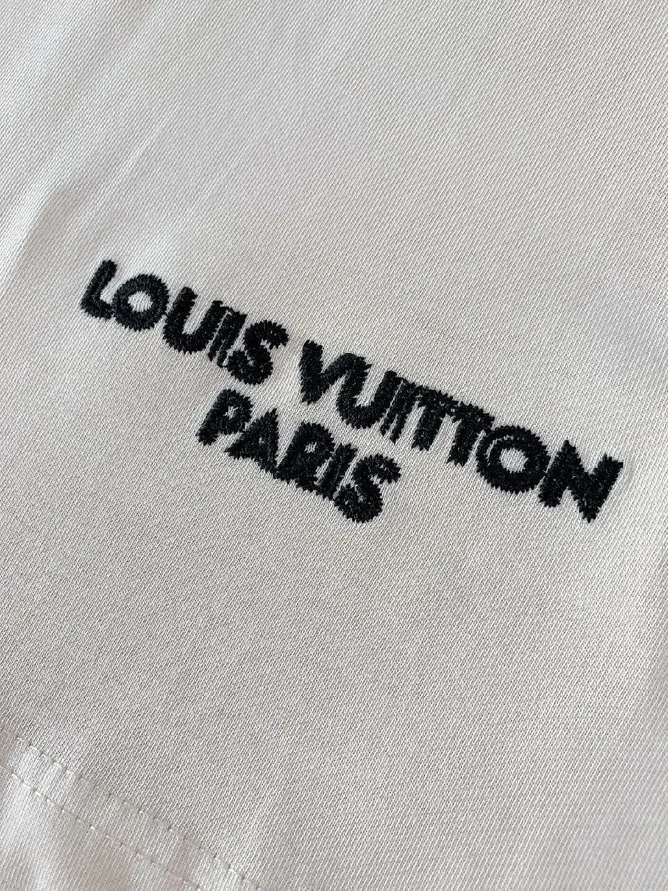 View 3 of Minimalist Off-White Cotton Tee with Signature L.V.M. Accent
