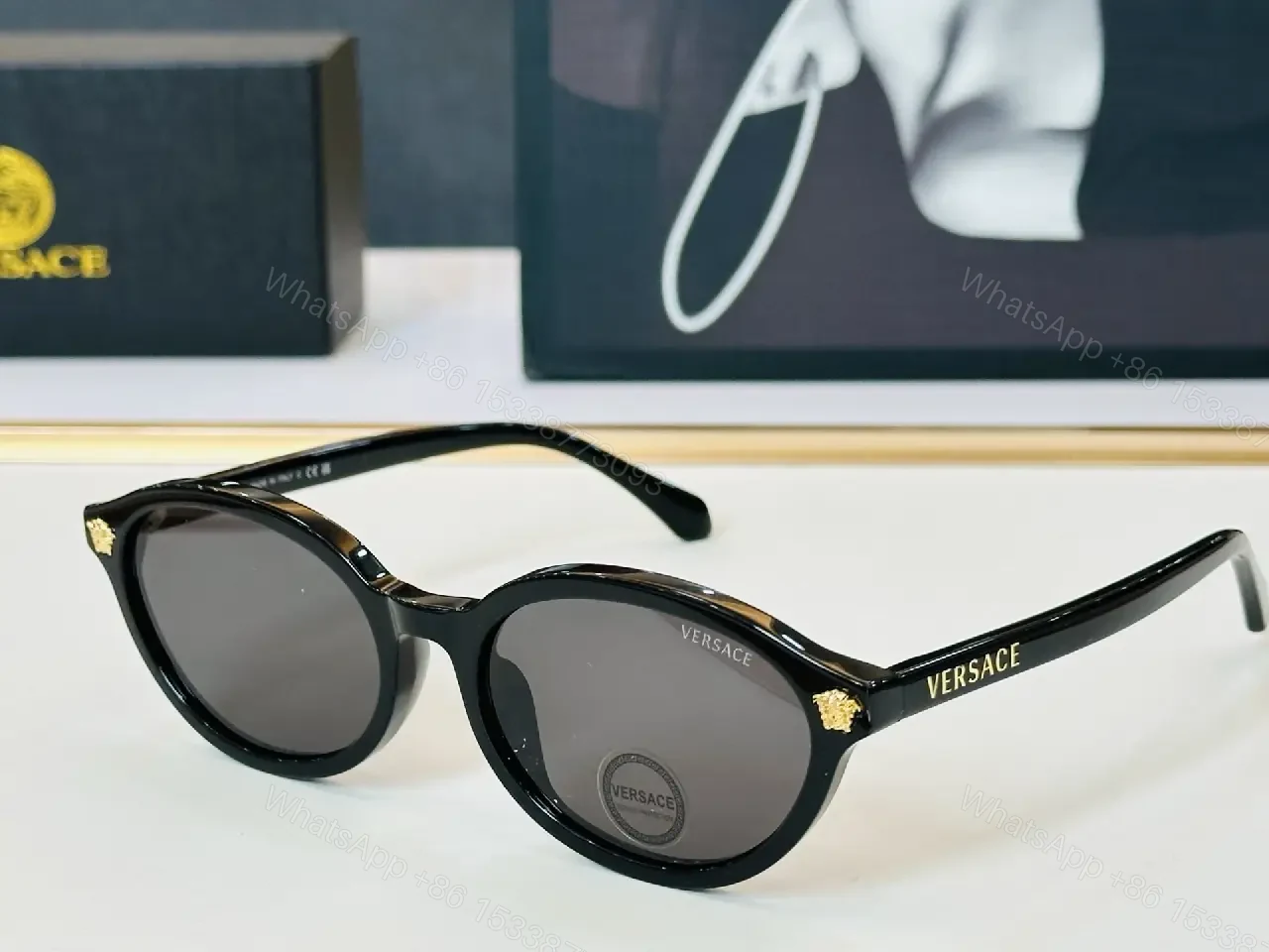 View 2 of Glassy Black Round Sunglasses with Gold Accents, UV400 Protection