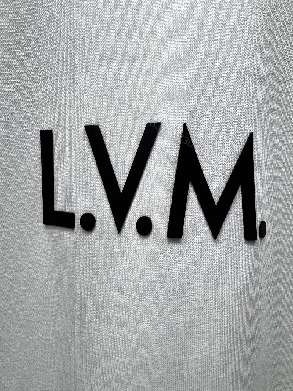View 6 of Minimalist White T-Shirt with Subtle LV.M Emblem - Premium Cotton