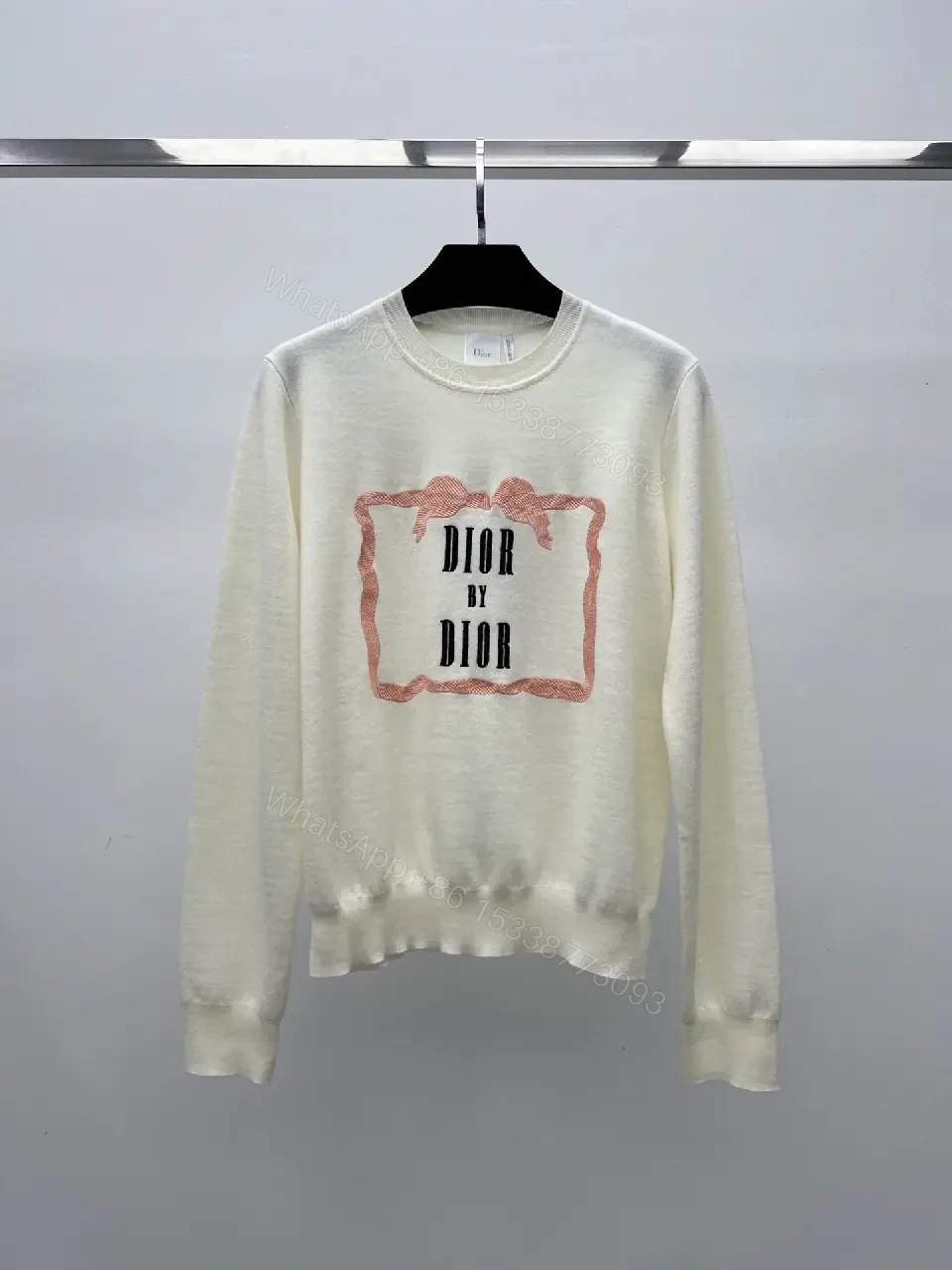 View 2 of cream cotton knit sweater with pink framed monogram print luxury casualwear