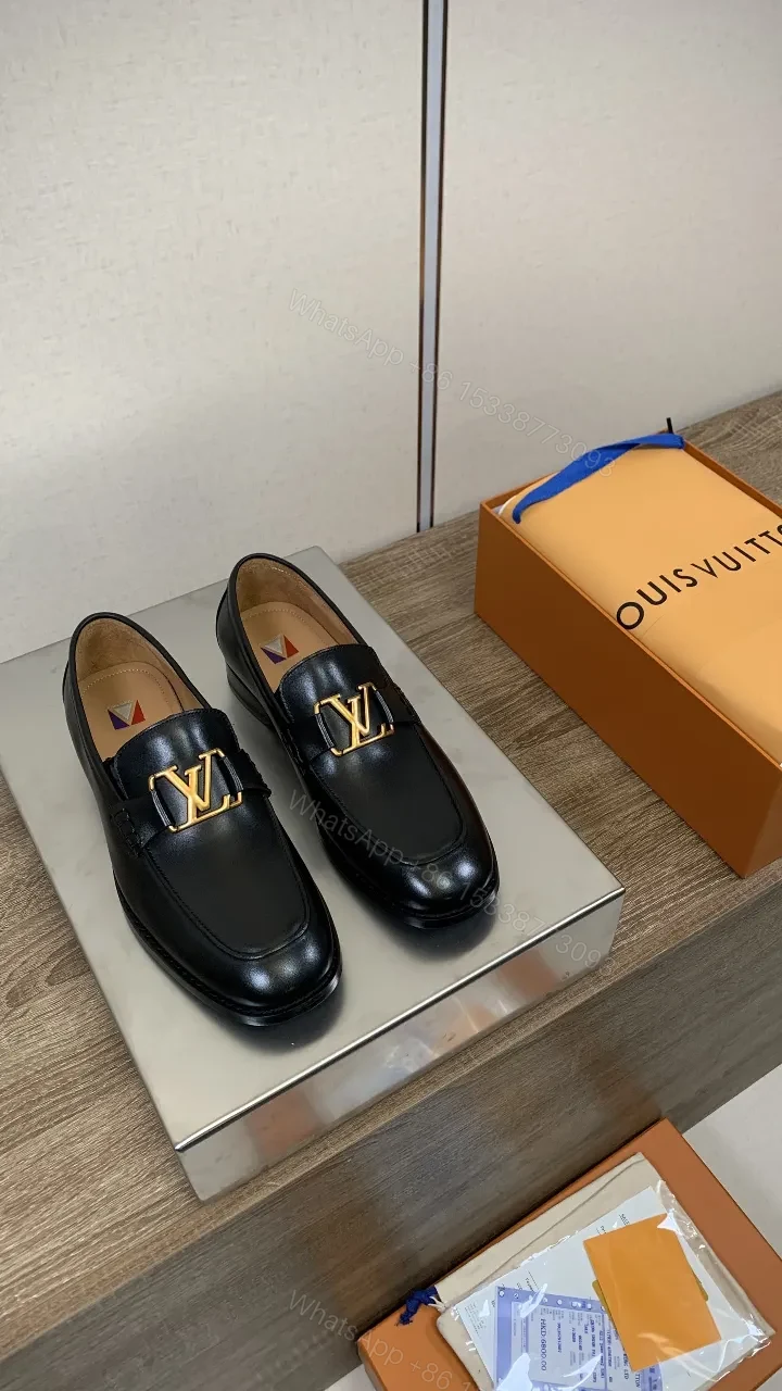 Chic Black Leather Penny Loafers with Gold Hardware — view 1