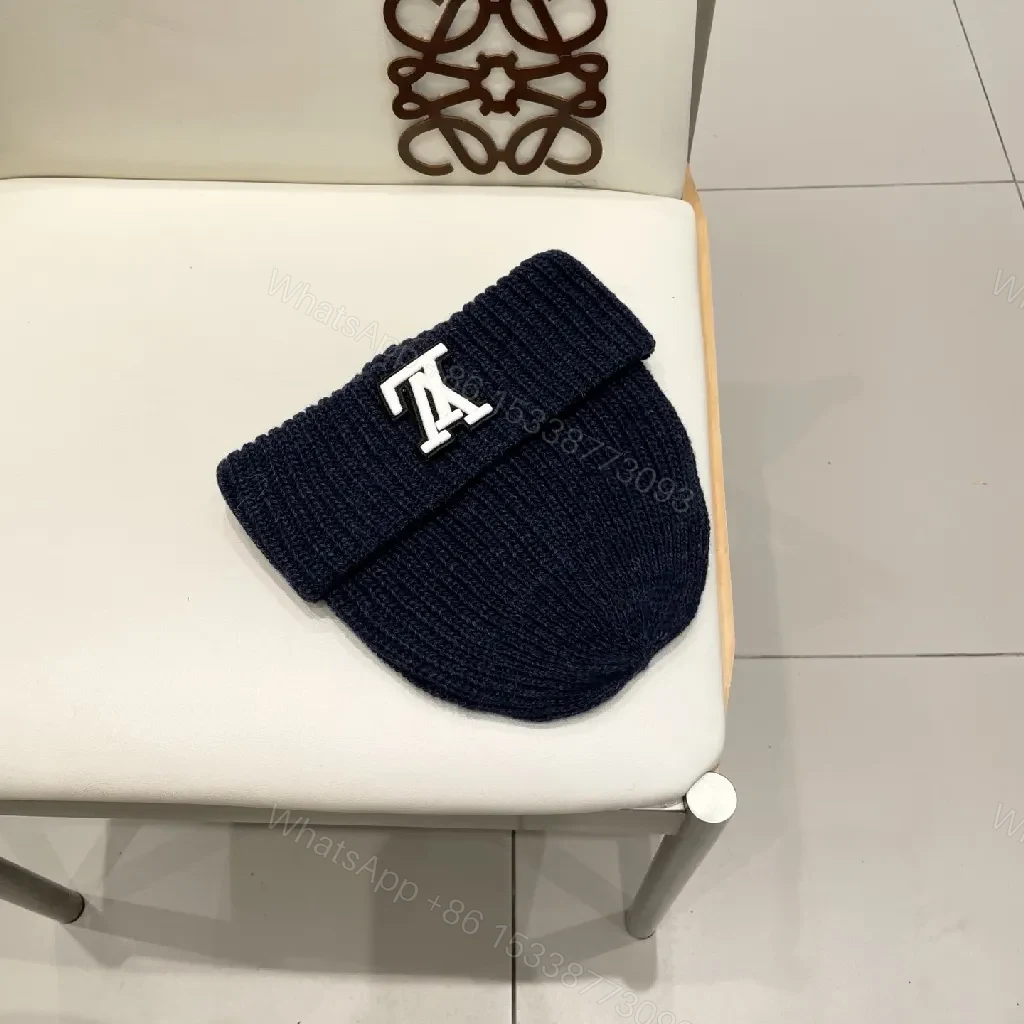 View 4 of Cozy Black Knit Beanie with Subtle Emblem Detail