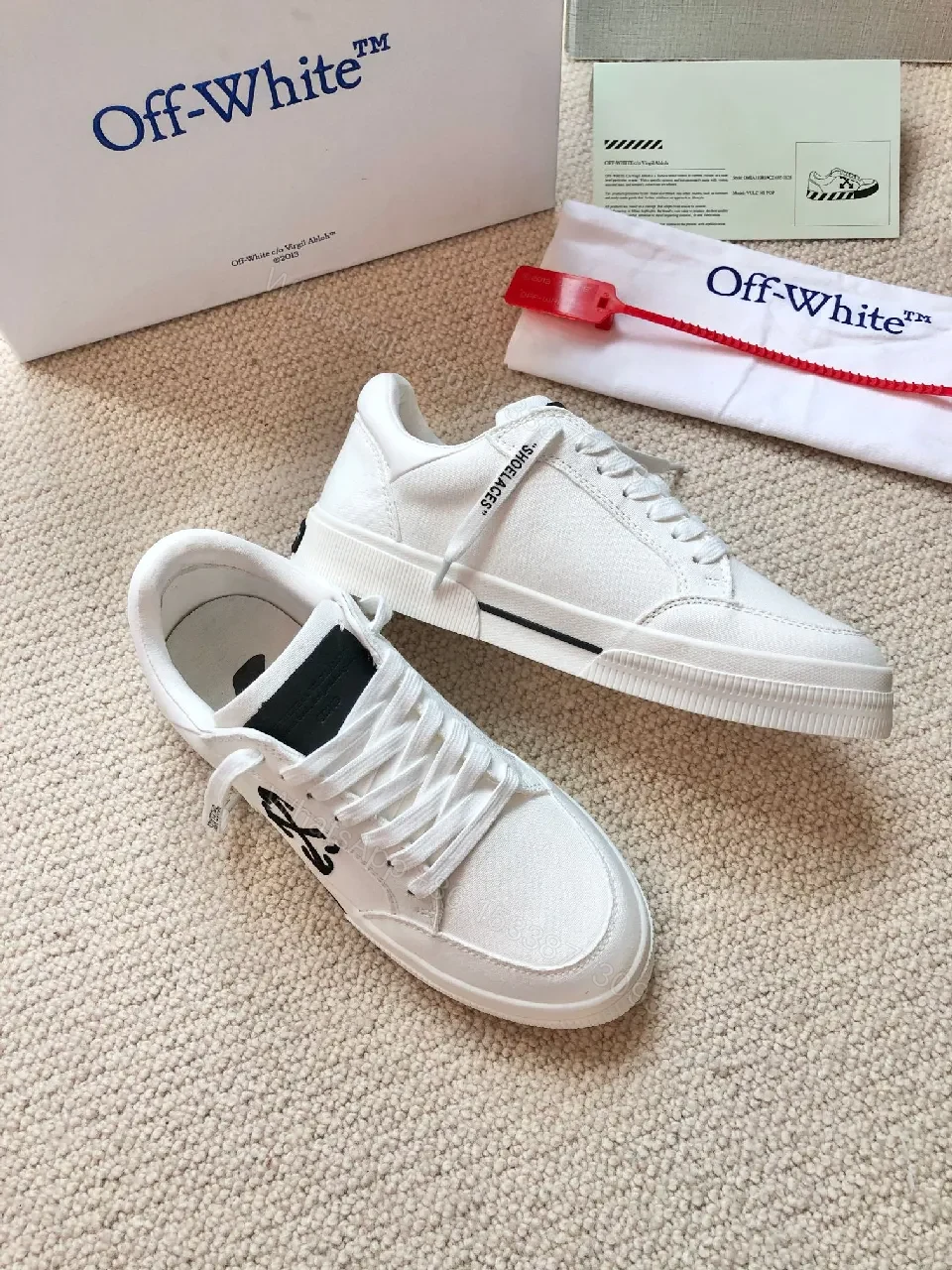 View 9 of Minimalist White Leather Low-Top Sneakers with Signature Detail