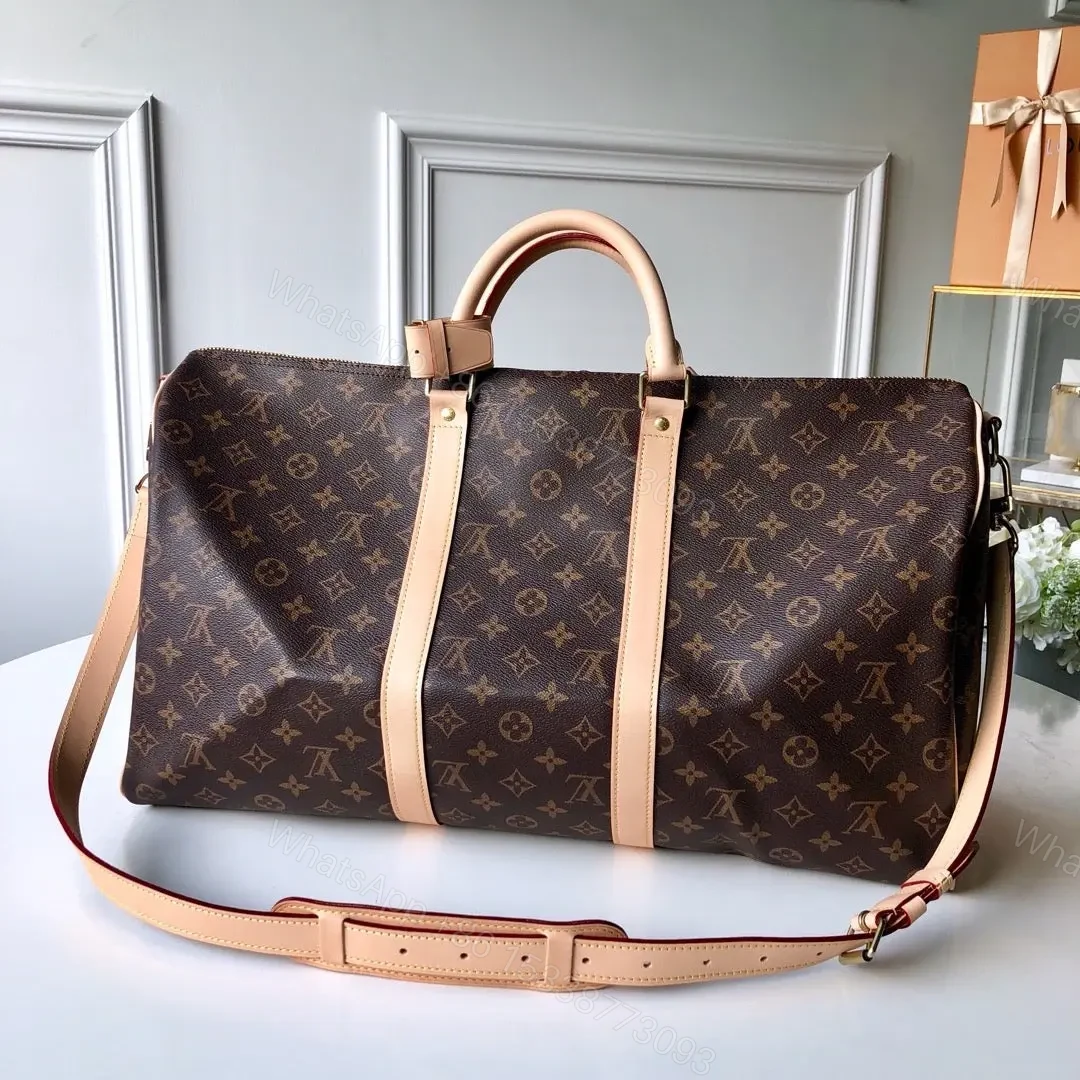 View 8 of LV Monogram Canvas Keepall Bandoulière 55 Leather Duffle Bag