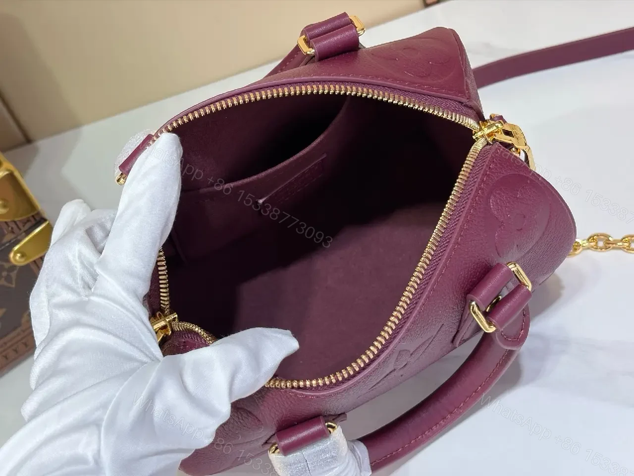 View 2 of Deep Plum Leather Satchel: Structured Top-Handle Bag with Embossed LV Motifs