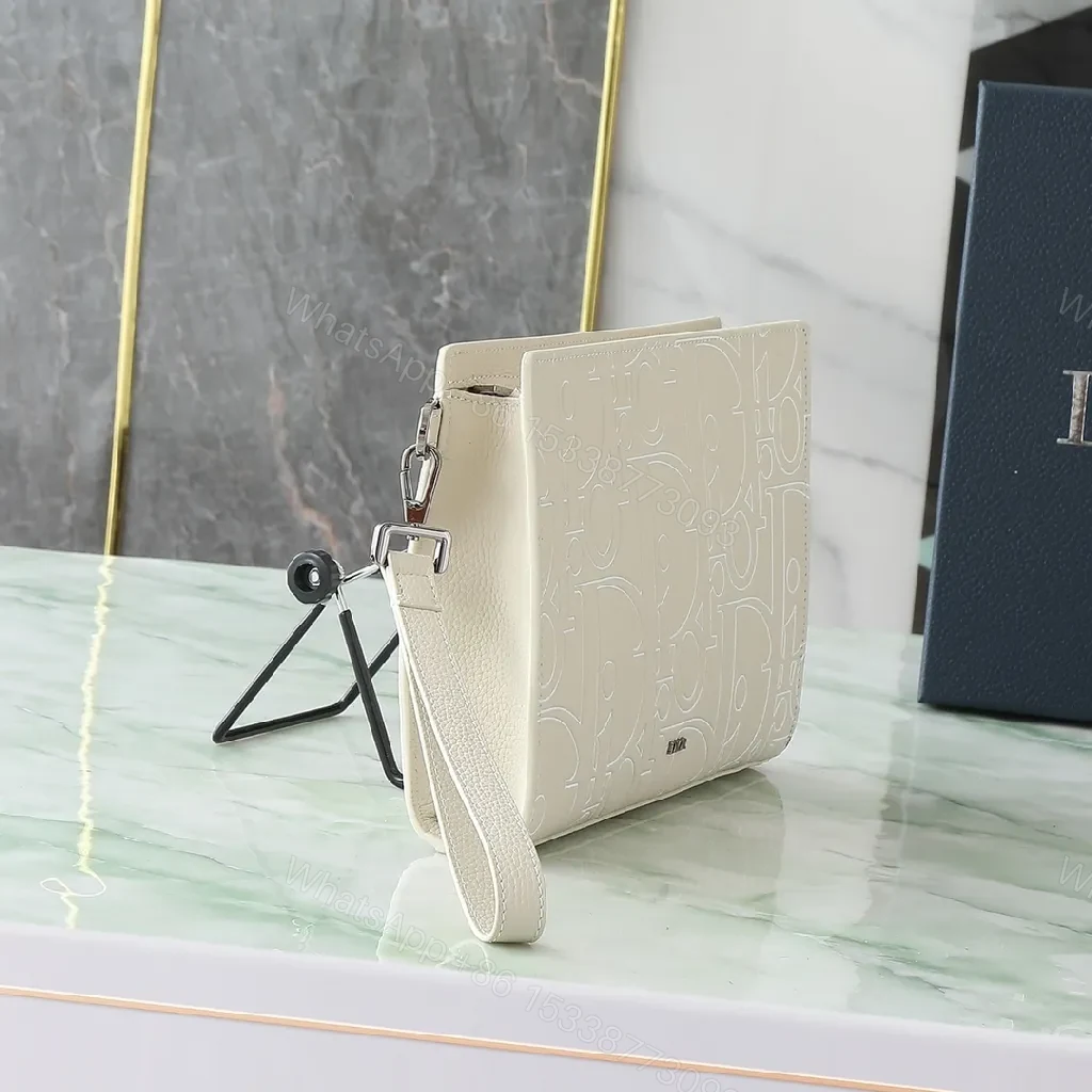 View 9 of Refined Monogram Clutch: Textured Grain, Silver Hardware, Lightweight Crossbody