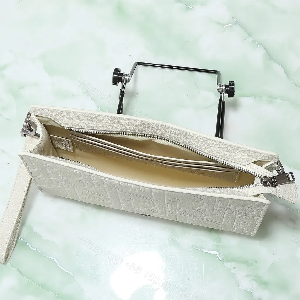 View 4 of Refined Monogram Clutch: Textured Grain, Silver Hardware, Lightweight Crossbody
