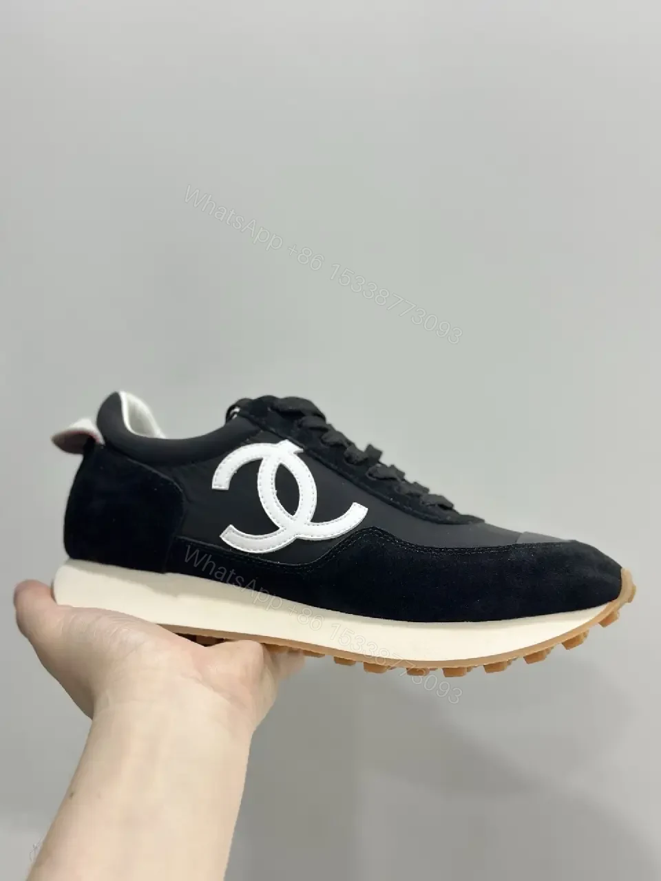 View 2 of Sleek Black Knit High-Top Sneaker with Signature Emblem, Luxury