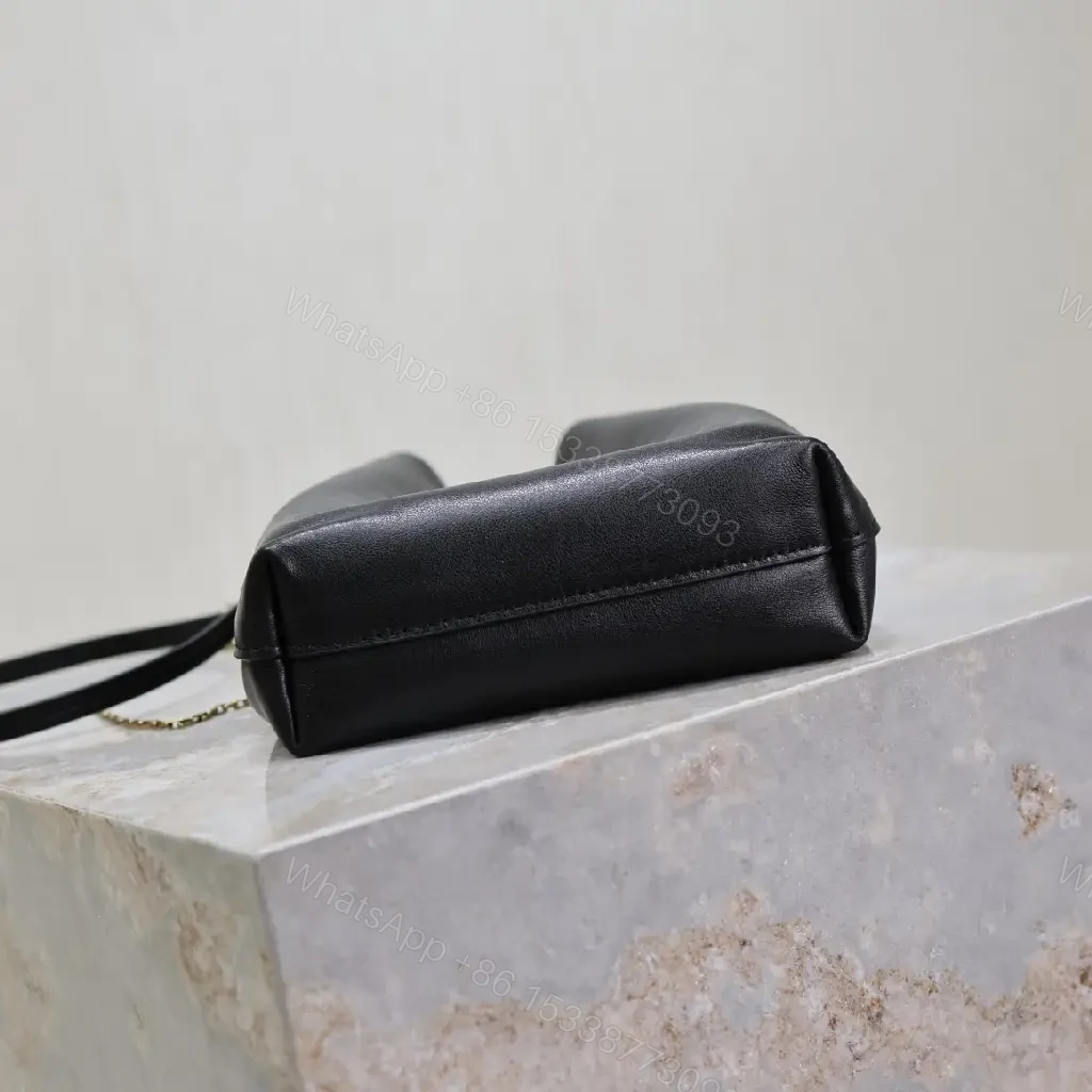 View 3 of Black leather bucket bag with gold-tone YSL monogram and chain straps for everyday luxury
