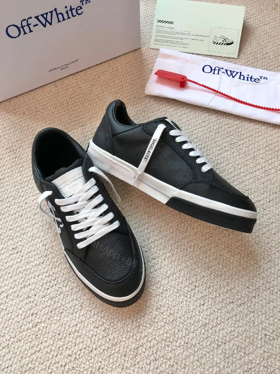 View 5 of Low-Top Black Pebbled Leather Sneakers with Signature Detailing