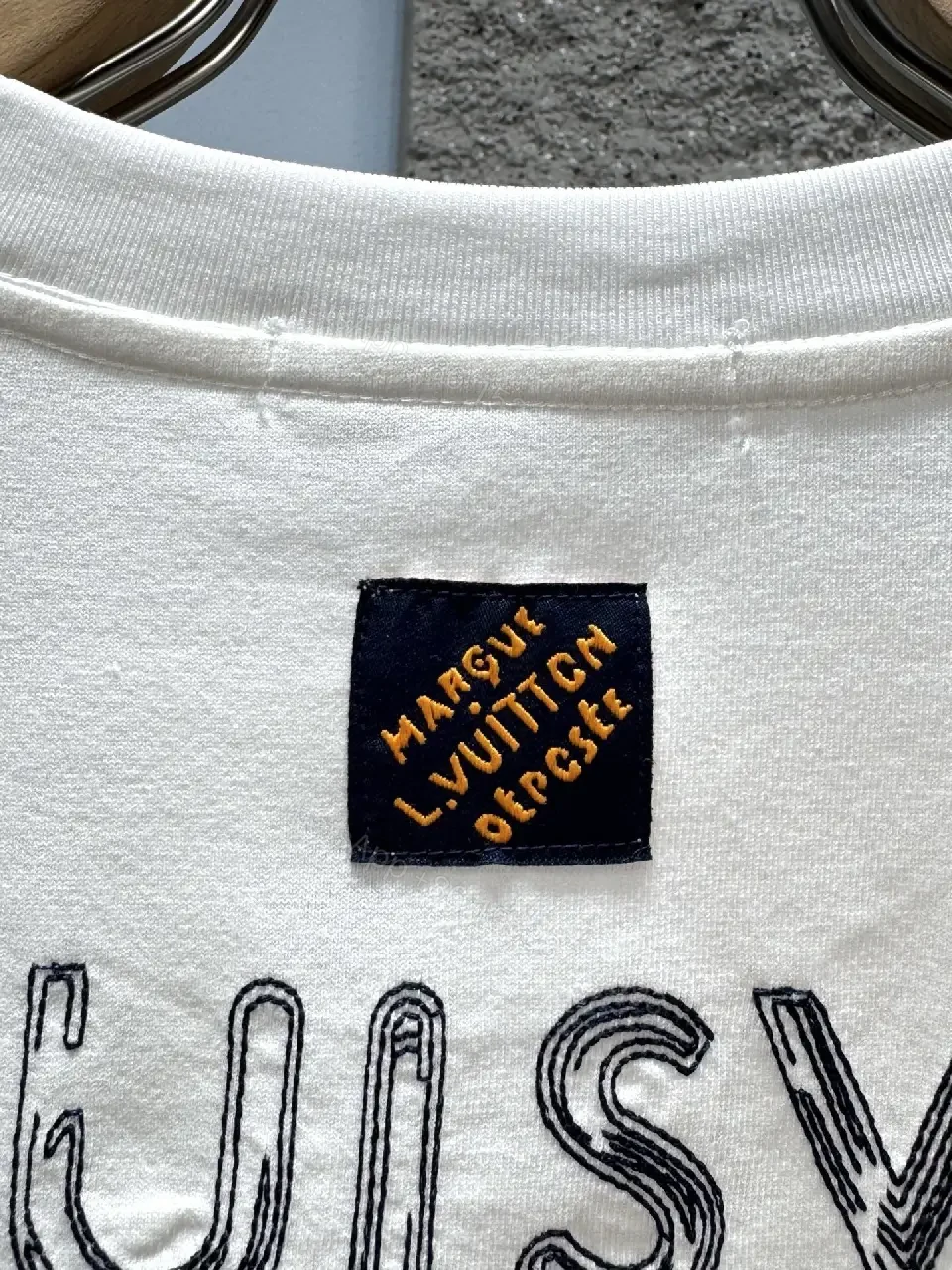 View 11 of Minimalist White Tee with Subtle L.V.M. Logo—Premium Everyday Essential