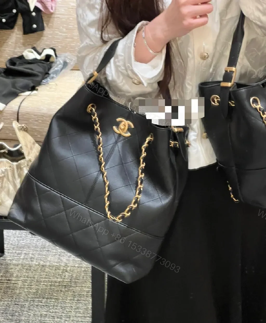 View 6 of Black Quilted Bucket Bag with Gold Chain Strap