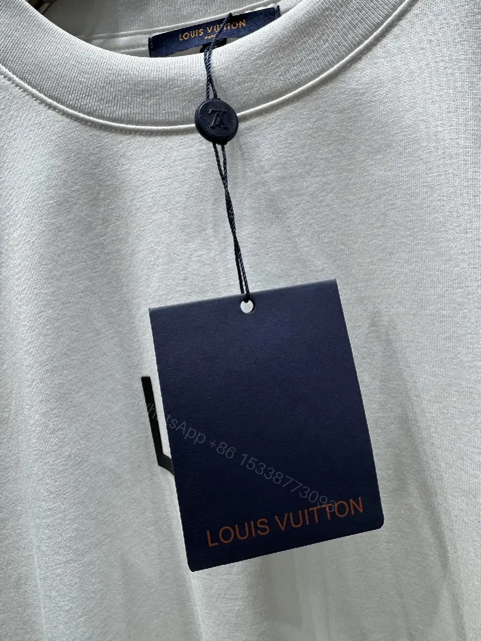 View 8 of Minimalist White T-Shirt with Subtle LV.M Emblem - Premium Cotton