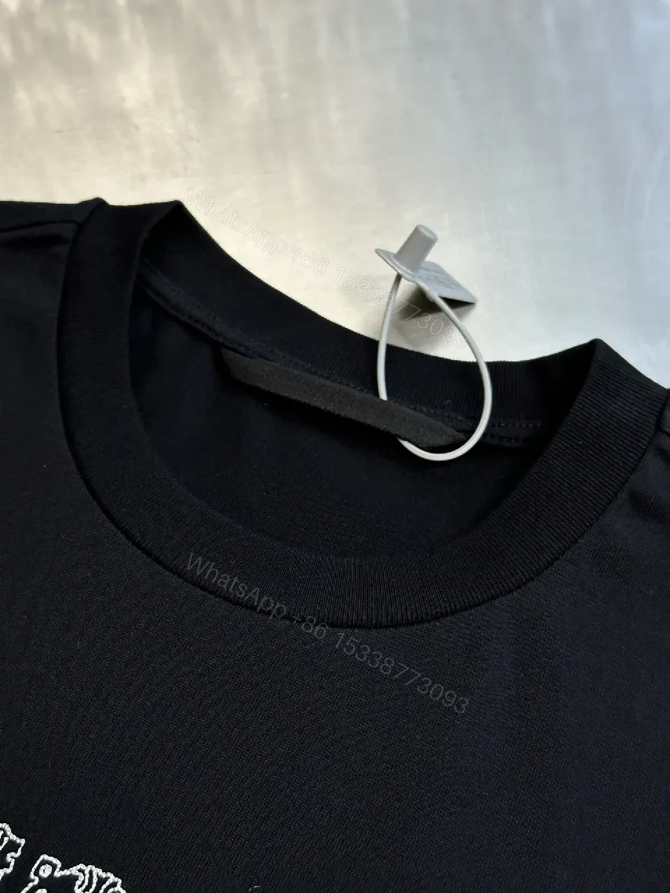 View 4 of Textured Logo Black Tee with Subtle Hardware - Premium Cotton Blend