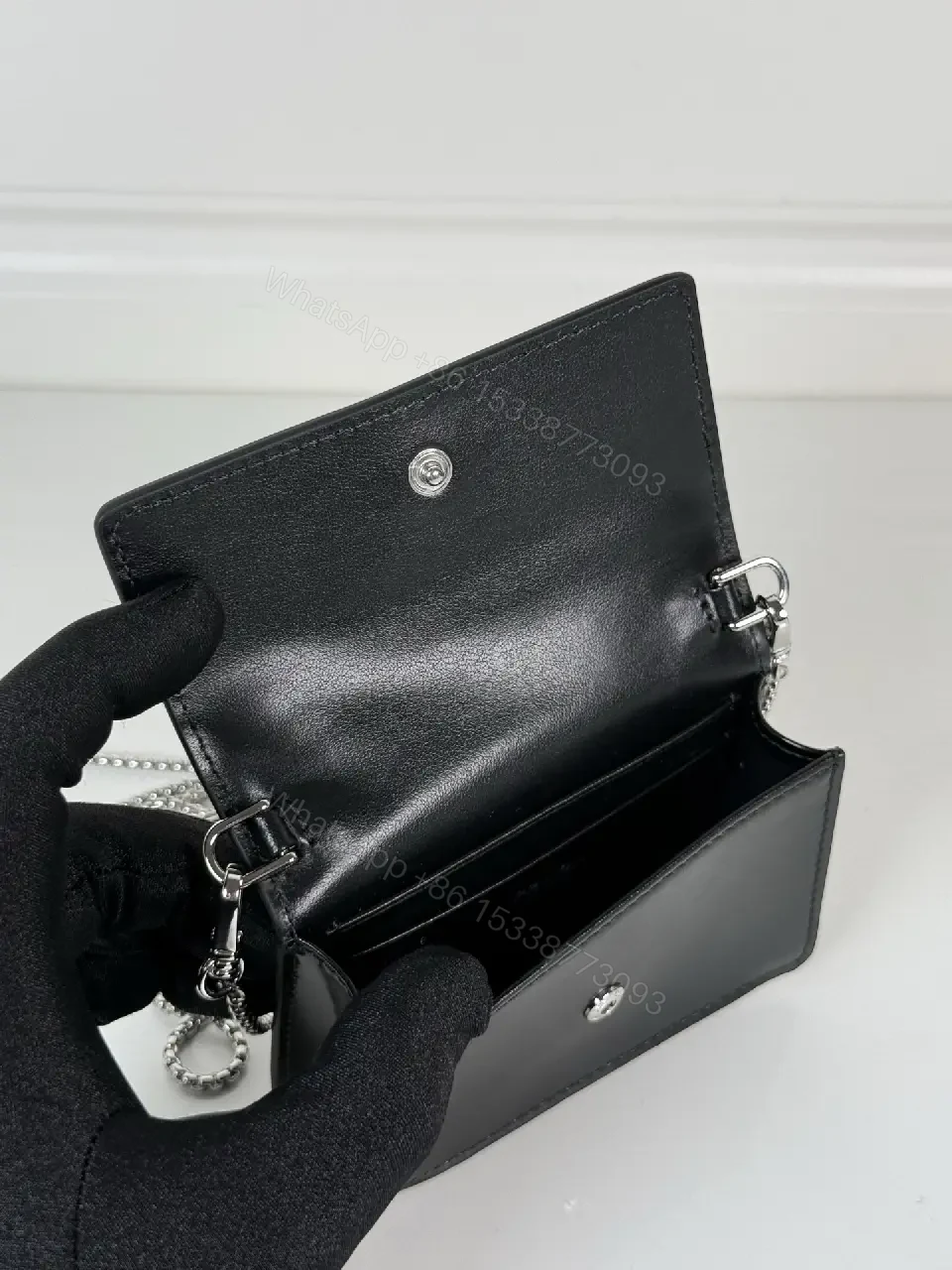 View 7 of Chic Black Leather Mini Bag with Signature Logo Chain