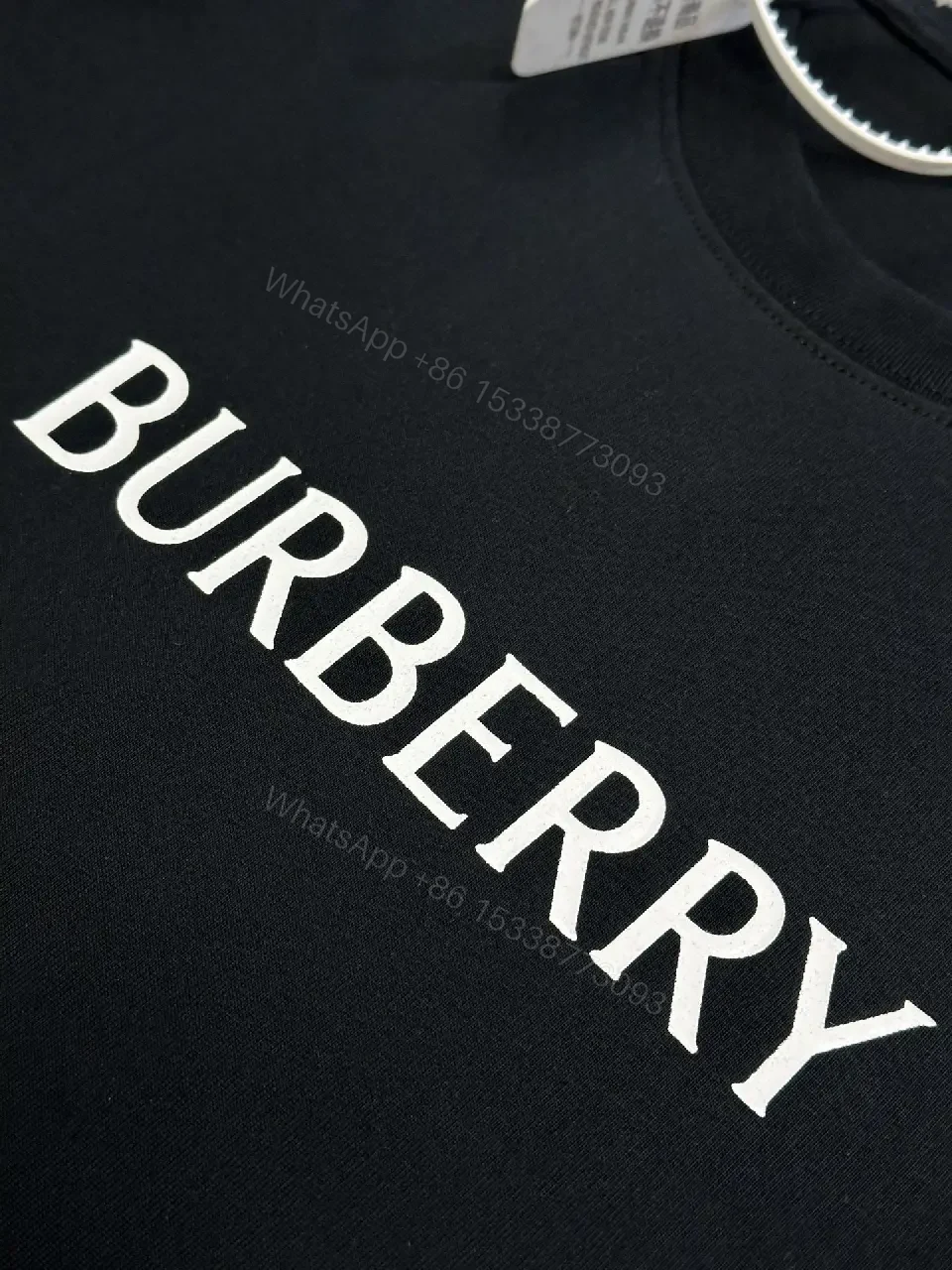 View 6 of Minimalist Black Cotton Tee | Relaxed Fit, Logo Accent, Everyday Luxury