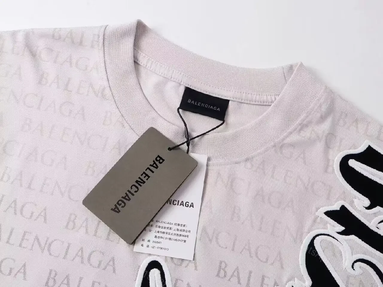 View 4 of Bold Monogram Tee: White Cotton with All-Over Black Script Pattern