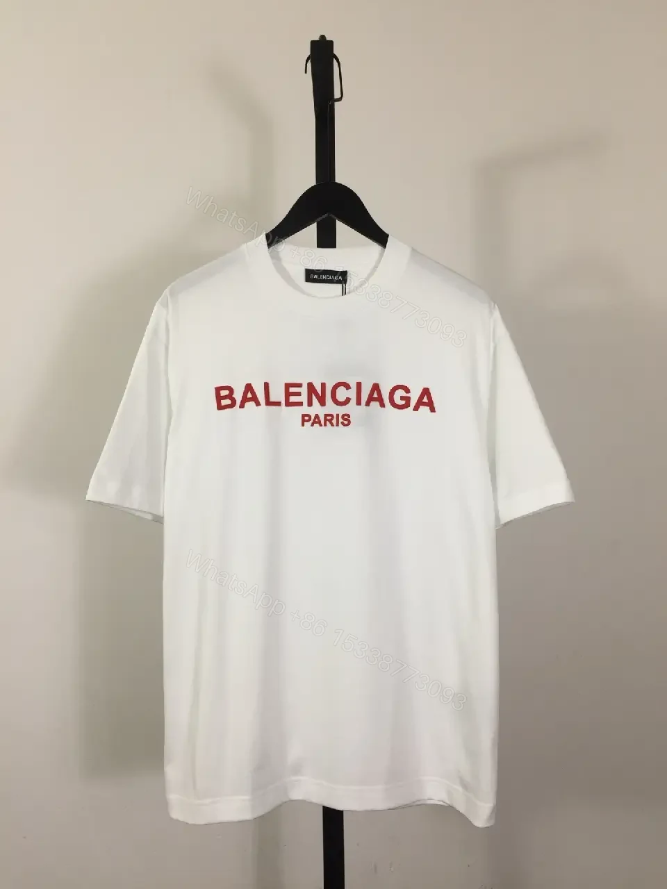 Minimalist White Logo Tee with Bold Red Crest — view 1
