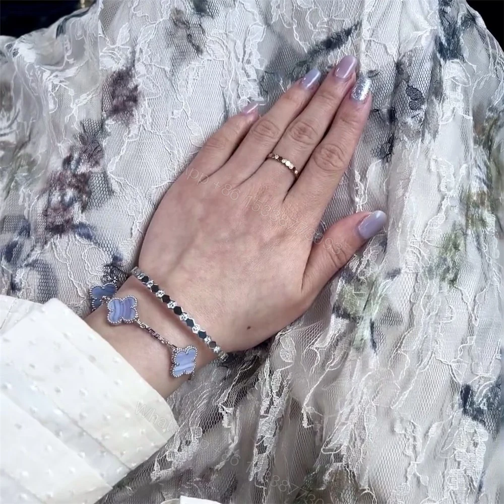 Chaumet bee my love bracelet stack with Cartier love bracelet and Van Cleef Alhambra bracelet — view 1