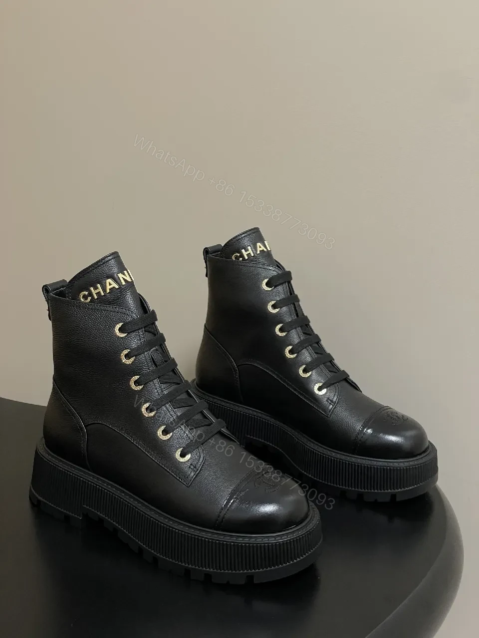 Black Leather Combat Boots with Gold Branding Feature — view 1