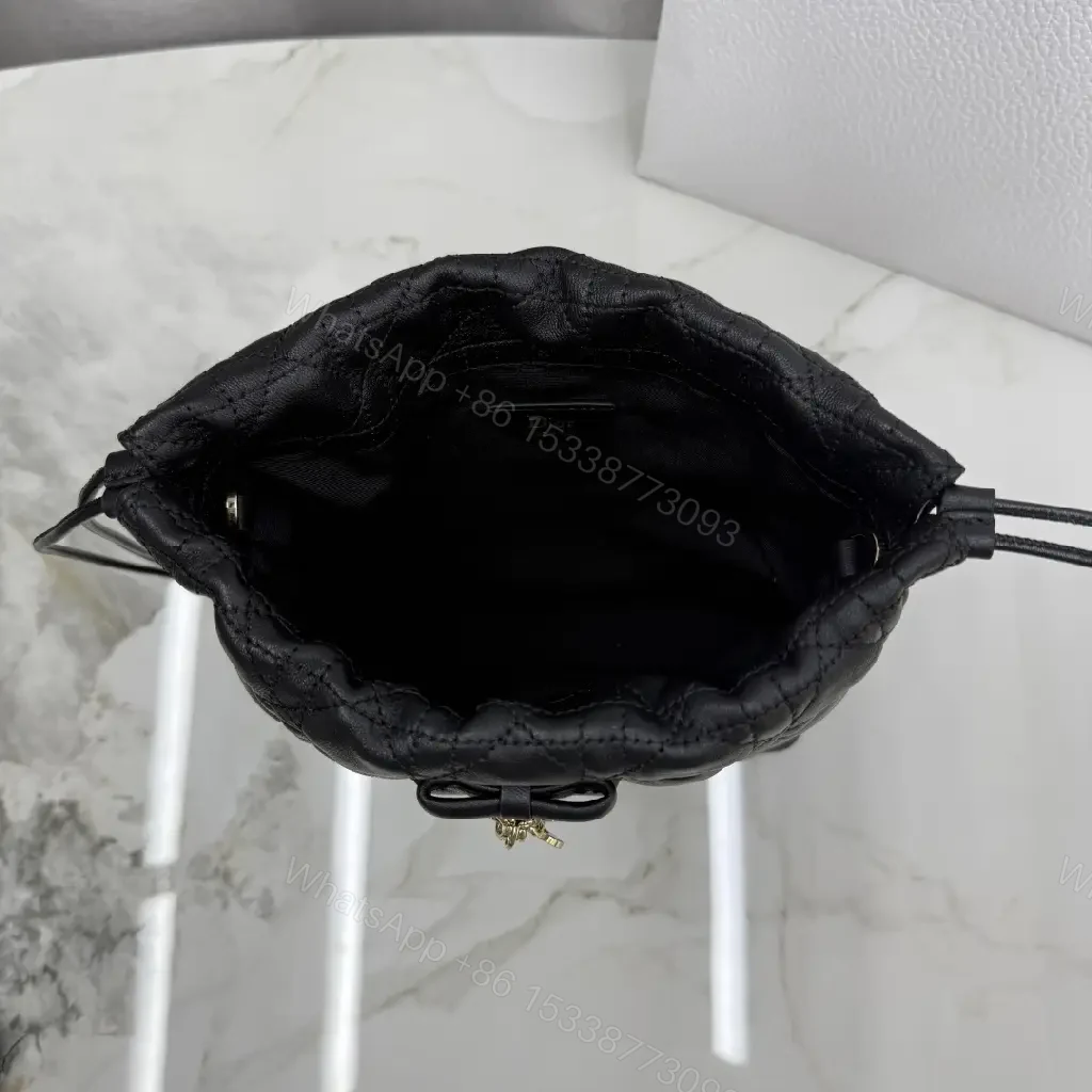 View 9 of Quilted Black Drawstring Bucket Bag with Gold Hardware
