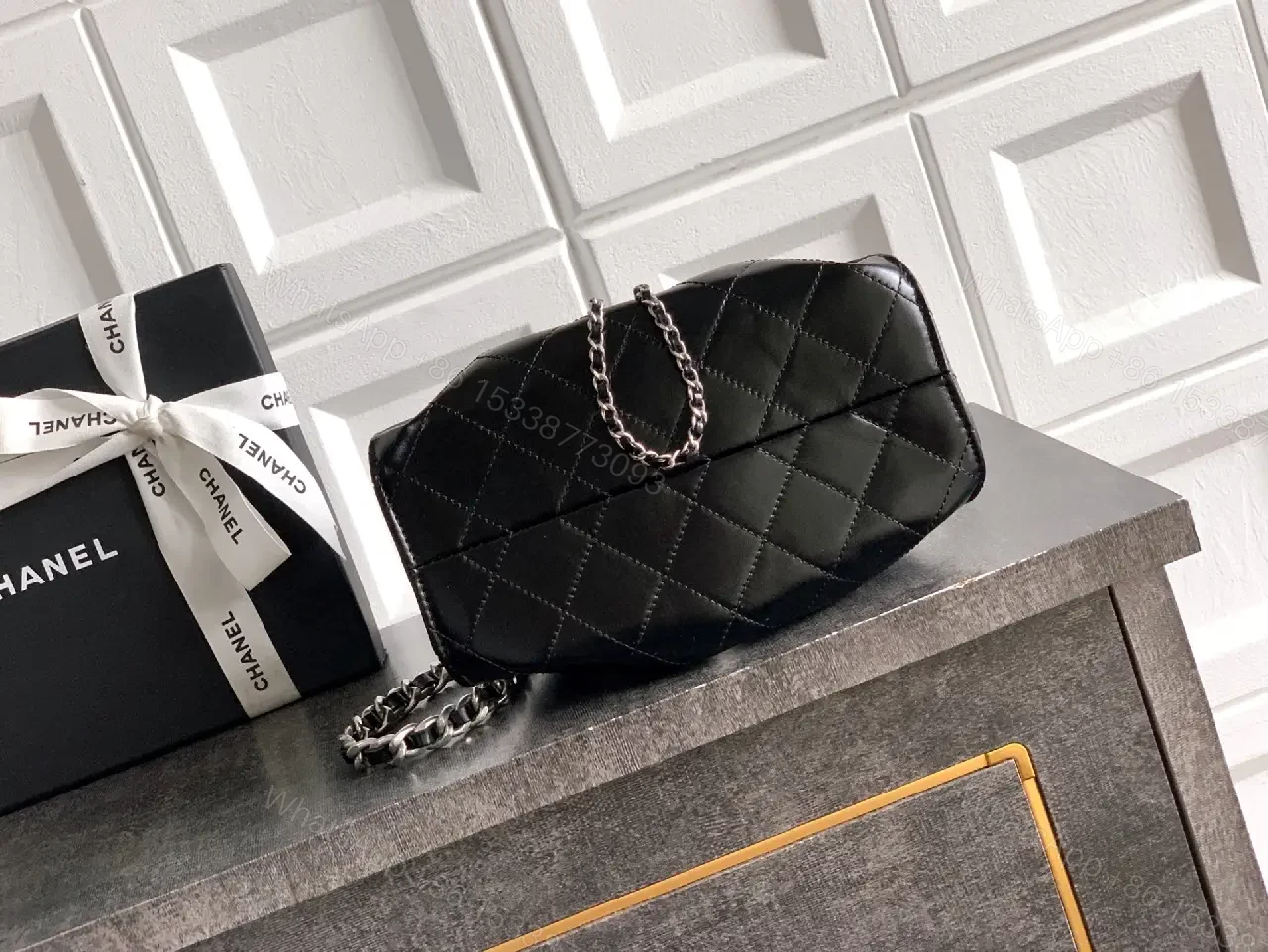 View 2 of Quilted Black Leather Bag with Chain Strap—Compact Elegance