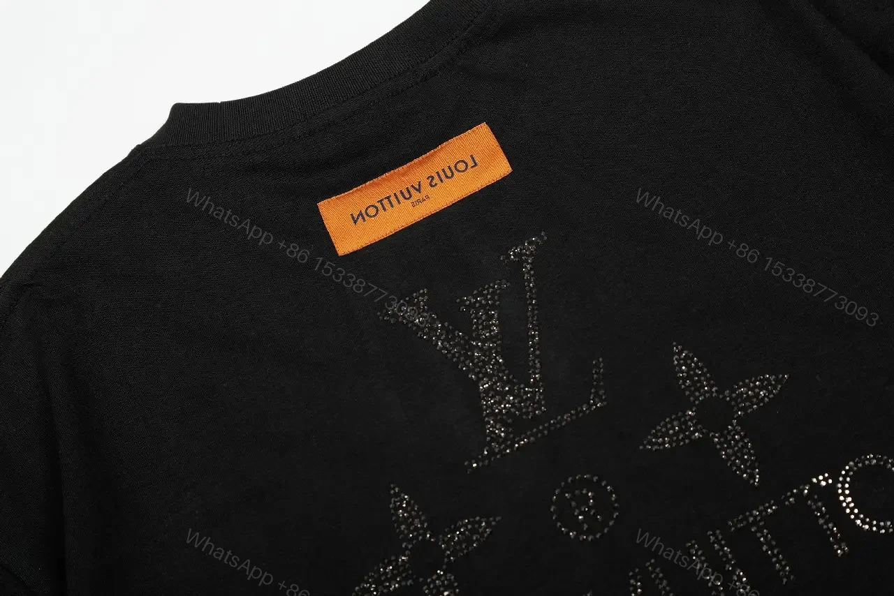View 9 of Minimalist Black Cotton Tee with Subtle Monogram Detail - Everyday Luxury